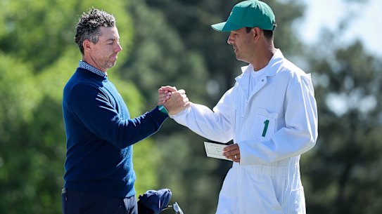 Rory McIlroy and caddie Harry Diamond  shake hands on the 18th after the first round of the 2026 Masters.