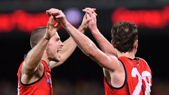 Bomberes David Zaharakis and Mitch Brown celebrate a goal on their way to victory at Adelaide Oval.