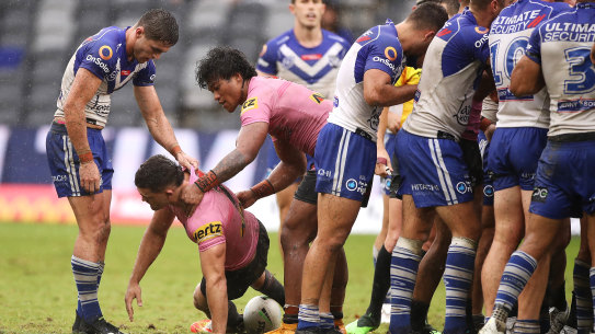 Nathan Cleary is helped to his feet after a careless high tackle.