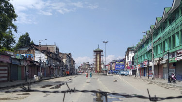 Kashmiri women walk at a deserted Lal Chowk square, a frequent site for anti-India protests, in Srinagar, Indian-controlled Kashmir, in August 2019.