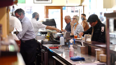 Customers eating at Pellegrini's Espresso Bar for the first time in months.