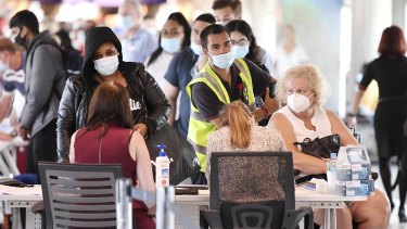 Incoming passengers are screened by police as they arrive at the domestic terminal at Brisbane airport on  Monday.
 