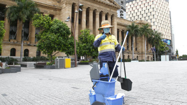A cleaner in the otherwise vacated King George Square in Brisbane.