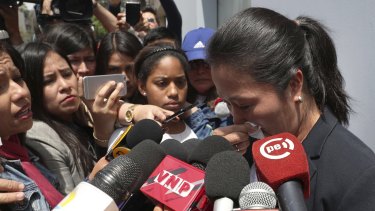 Keiko Fujimori, daughter of Peru’s former president Alberto Fujimori, cries as she speaks with reporters outside of her father’s home in Lima, Peru on Wednesday.