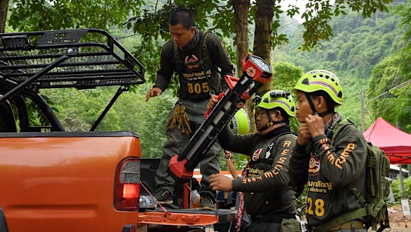 Thai volunteers arrive at the base camp where the rescue operations are being planned for the 12 boys and their soccer coach.
