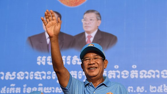 Prime Minister Hun Sen greets the crowd at the last Cambodian People’s Party rally before the election.