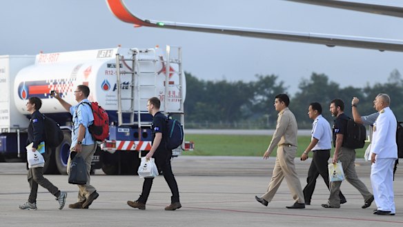 Richard Harris, second from left, and Australian support staff board an Australian RAAF plane bound for Canberra, in Chiang Rai, Northern Thailand. 