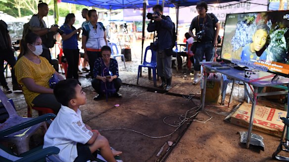 Beam Wongsookjan, 5, second from left,  watches footage of his older brother and the other boys.