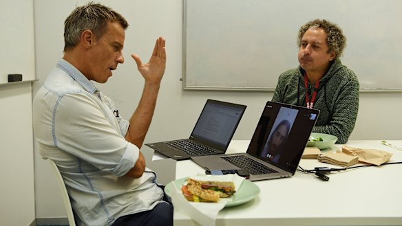 Journalist Tim Elliott and translator  Omid Tofighian talk to Behrouz Boochani over lunch.