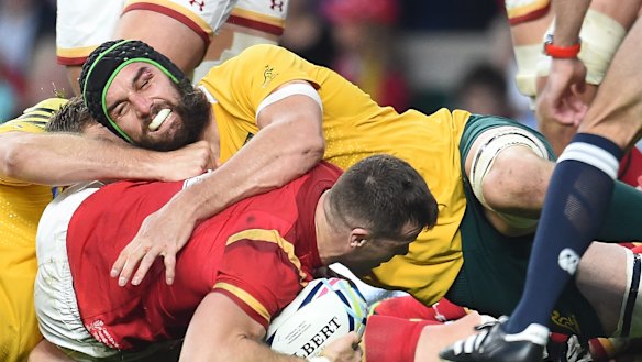 Advantage Australia: Gareth Davies is stopped short of the Wallabies' try line by Scott Fardy during their Rugby World Cup 2015 pool A match. Australia won the clash 15-6.