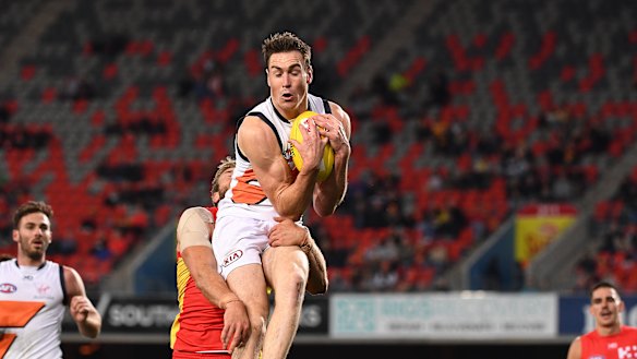 Giant leap: Jeremy Cameron flies against Gold Coast in his Coleman Medal-sealing performance. 