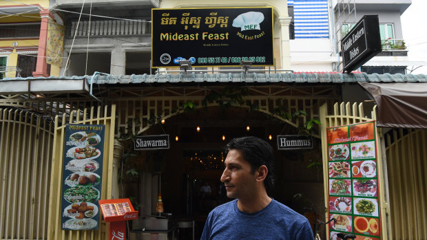 Abdullah in front of his restaurant, Middle East Feast, in Phnom Penh.