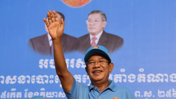 Prime Minister Hun Sen greets the crowd at the last Cambodian People’s Party rally before the election.