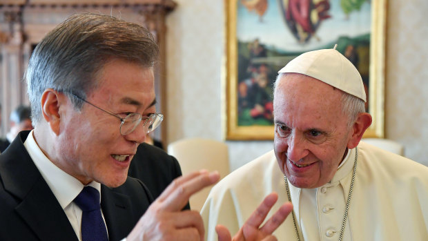 South Korean President Moon Jae-in, left, talks with Pope Francis during their private audience, at the Vatican, on Thursday.
