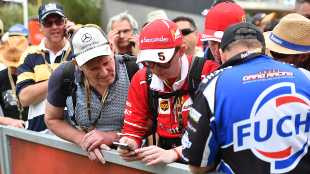 John Walker (left) and Raphael Zink (right) check their phones for updates on the event.