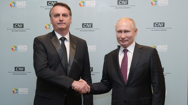 Russian President Vladimir Putin, right, and Brazil's President Jair Bolsonaro shake hands at the BRICS summit in Brazil last week.