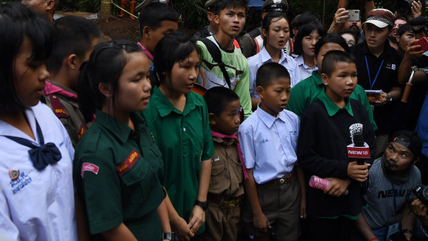 Friends and classmates of the trapped boys in Tham Luang cave sing for them.