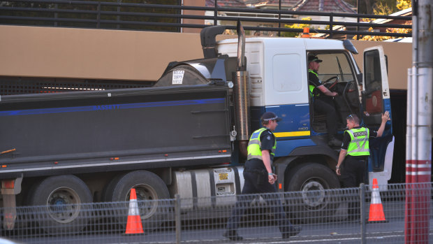 A truck struck and killed a woman as she crossed the road in Kew. 