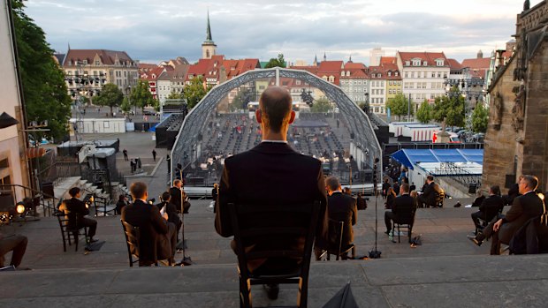 Singers sit apart for a rehearsal of the Cathedral Steps open air festival in front of Mariendom (Cathedral of Mary) and St Severi's Church in Erfurt, Germany.