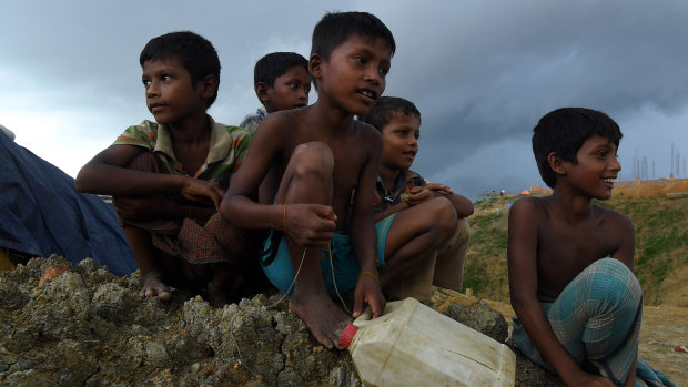 Rohingya children sit on the side of a road in Kutupalong camp, part of the largest refugee camp in the world, home to over 400,000 of 900,000 Rohingya refugees who fled Myanmar in August 2017. Cox’s Bazar, Bangladesh. 