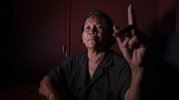 Bou Sokhom holds up a clean finger to indicate she will be boycotting Cambodia's general election.