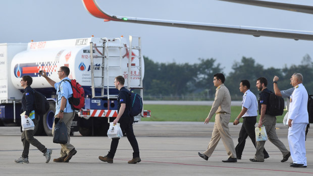Richard Harris, second from left, and Australian support staff board an Australian RAAF plane bound for Canberra, in Chiang Rai, Northern Thailand. 