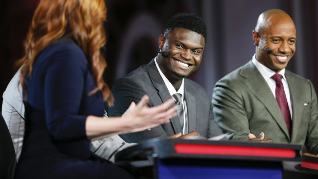Zion Williamson (centre) is interviewed on ESPN at NBA draft lottery.