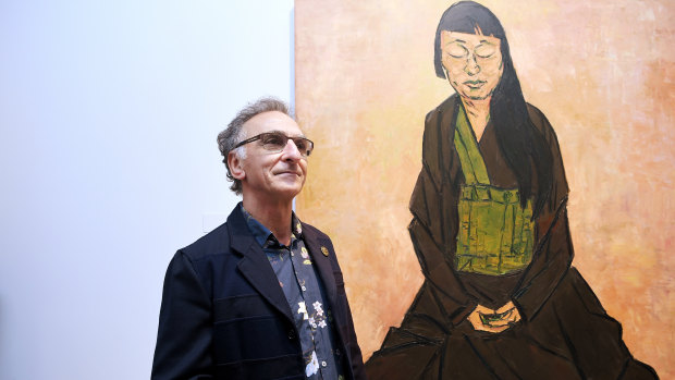 Winner of the 2019 Archibald Prize, artist Tony Costa, in front of his winning portrait titled Lindy Lee on Friday. (Full image below.)