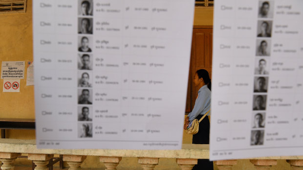 An election official stands among the voter lists at a polling station.