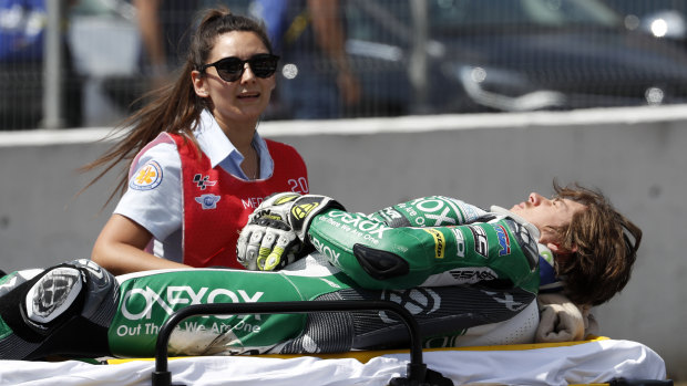 Moto2 rider Remy Gardner is carried off on a stretcher after a crash in Spain.