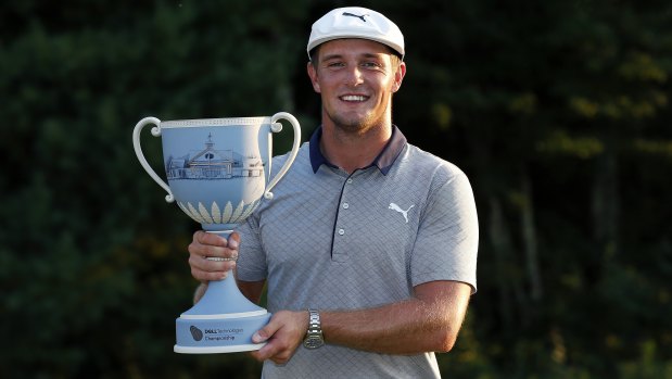 On fire: Bryson DeChambeau holds the trophy aloft for the second consecutive week.