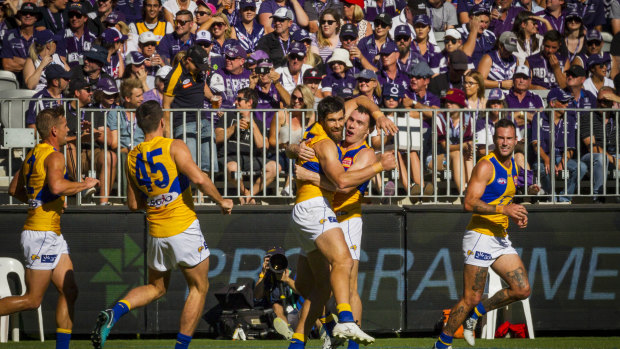 Purple pain: Dockers fans look on as West Coast players celebrate a goal during the Western Derby.