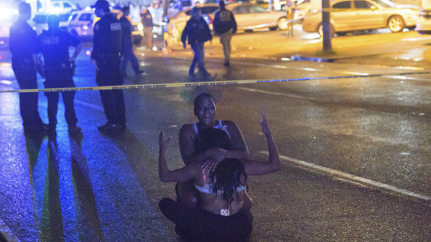 The scene after two armed individuals opened fire on a crowd gathered outside a strip mall in New Orleans.