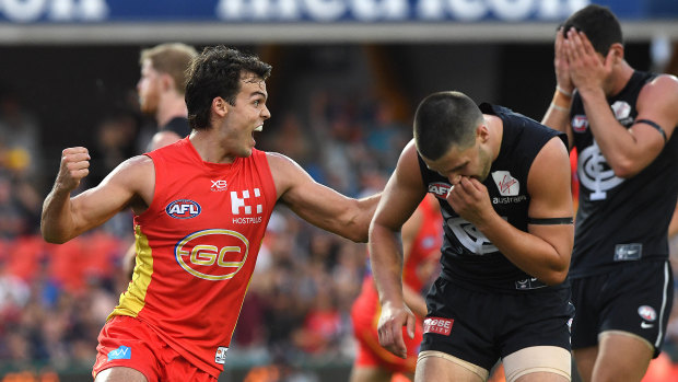 Blue Sun day: Carlton players react after last-gasp snap by Gold Coast's Jack Bowes (left).