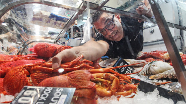 George Milonas, owner of George the Fishmonger, grabs a cray for a customer.