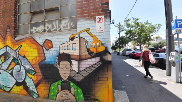 A graffiti piece depicting demolition of the Corkman pub, directly across the road from the site.