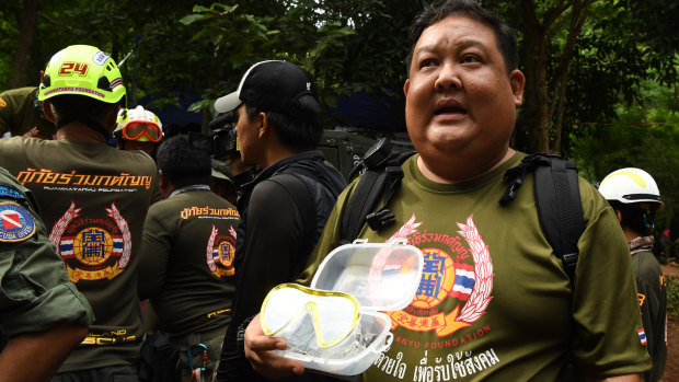 A members of a Thai rescue team holds goggles which will be delivered to the trapped boys.