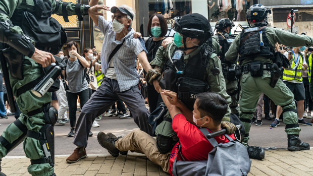 Pro-democracy supporters scuffle with riot police during a rally in Hong Kong. 