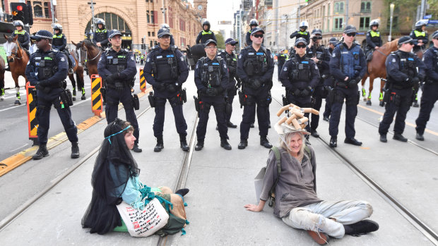 Extinction Rebellion protesters block Flinders Street.