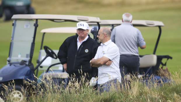 Then-President Donald Trump waits on the 4th tee at Turnberry golf course, Scotland in 2018.