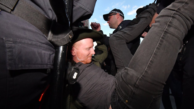 Police remove a protester.