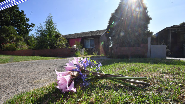 Flowers left at the scene in Heidelberg West where a woman was found dead in her home.