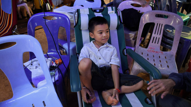 Beam Wongsookjan, 5, watching footage of his brother of Akekarat Wongsookjan 14, who is trapped in the cave.