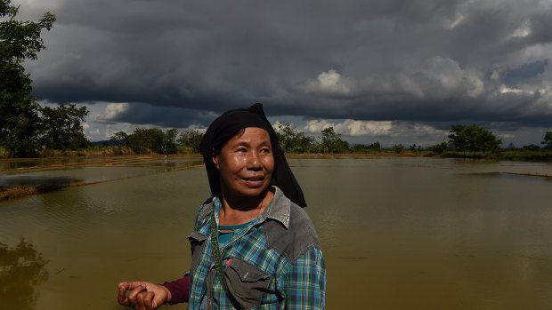 Noy Kerdkaew walks around her flooded rice farm near Tham Luang cave, Thailand.