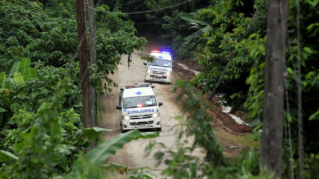 Ambulances carrying the 10th and 11th boys rescued drive away from the cave.