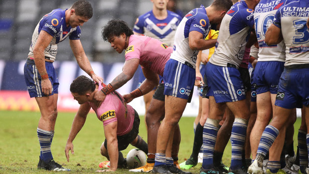 Nathan Cleary is helped to his feet after a careless high tackle by Dallin Watene-Zelezniak of the Bulldogs a fortnight ago.