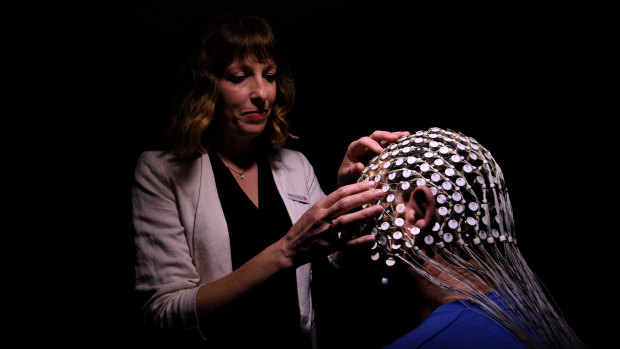 Dr Angela D’Rozario adjusts a high density EEG sensornet that monitors sleep brain waves on a patient