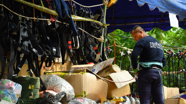 A Thai Navy diver prepares his equipment at the base camp at Tham Luang cave after a diver has died overnight.