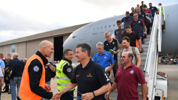 Emergency Management Commissioner Andrew Crisp greets CFA members returning home.