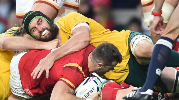 Advantage Australia: Gareth Davies is stopped short of the Wallabies' try line by Scott Fardy during their Rugby World Cup 2015 pool A match. Australia won the clash 15-6.